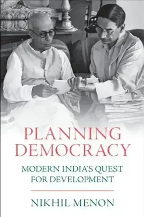 Black & white, statistician P. C. Mahalanobis in glasses, discussing papers with a younger man.